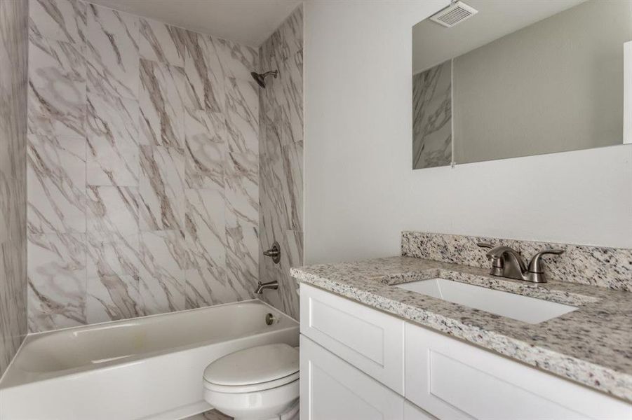 Bathroom featuring bathing tub / shower combination and vanity