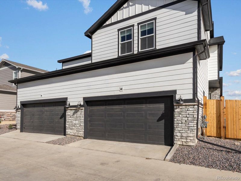 Front exterior of a new home in Horizon Uptown: The Mountain Collection, Aurora, CO, highlighting curb appeal (Image 21). Front exterior of a new home in Horizon Uptown: The Mountain Collection, Aurora, CO, highlighting curb appeal (Image 21).