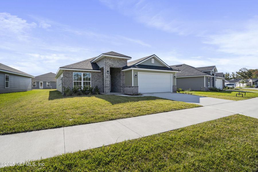 Front exterior of a new home in Summerglen, Jacksonville, FL, highlighting curb appeal (Image 24).