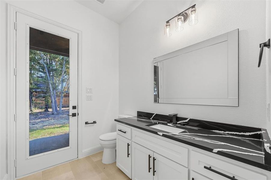 Half bathroom with vanity and toilet