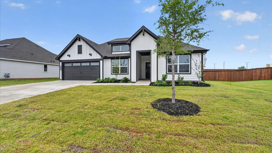Front exterior of a new home in Sandstone Estates, Granbury, TX, highlighting curb appeal (Image 2). Front exterior of a new home in Sandstone Estates, Granbury, TX, highlighting curb appeal (Image 2).
