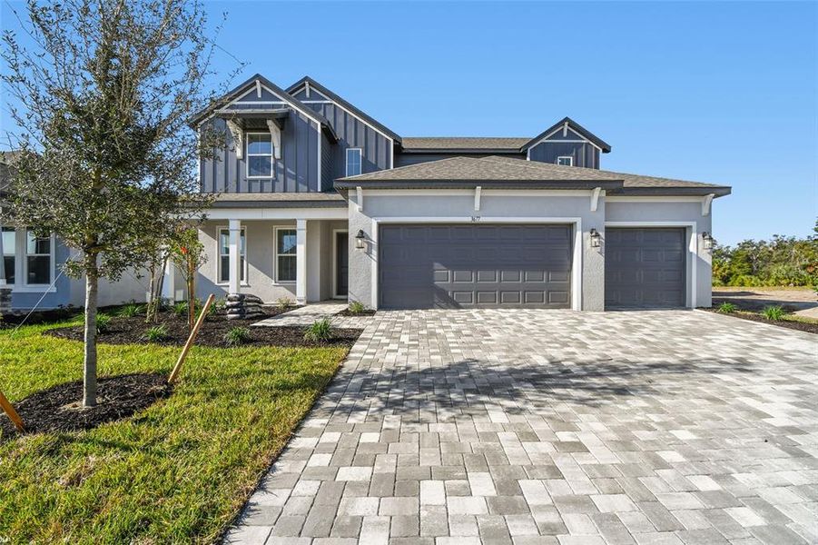 Front exterior of a new home in Creeks Edge at Twin Rivers, Parrish, FL, highlighting curb appeal (Image 27).