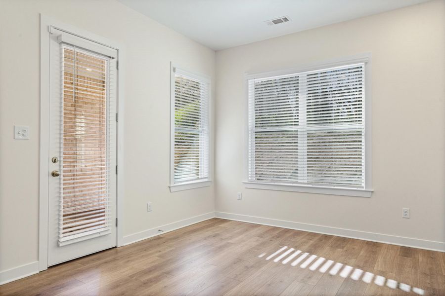 Unfurnished room with baseboards and light wood-style flooring