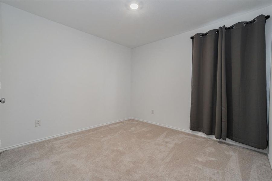 Unfurnished room with light colored carpet and baseboards