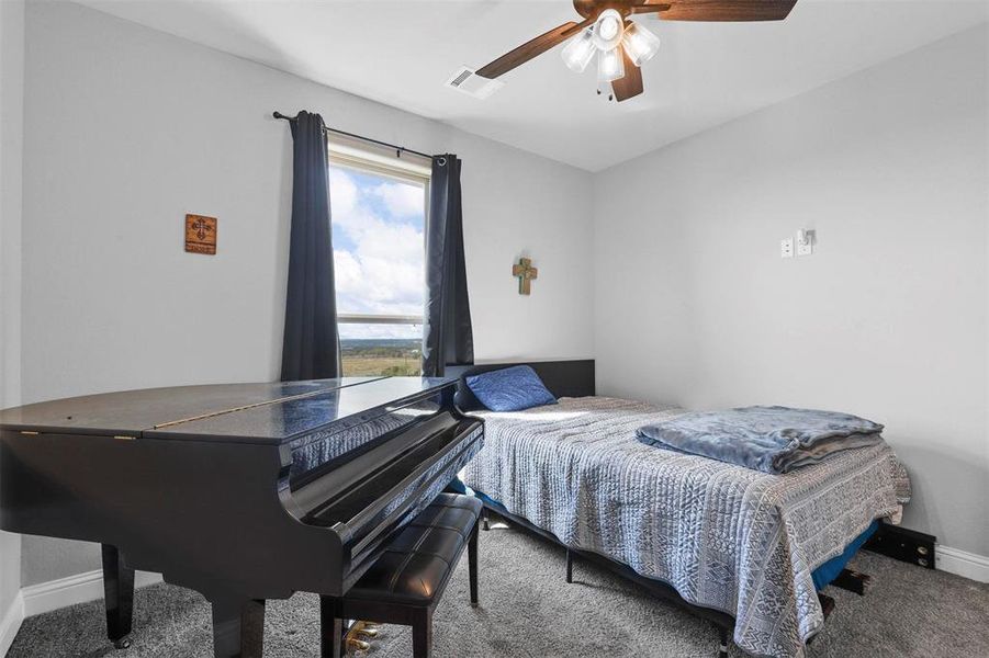 Bedroom with ceiling fan and carpet