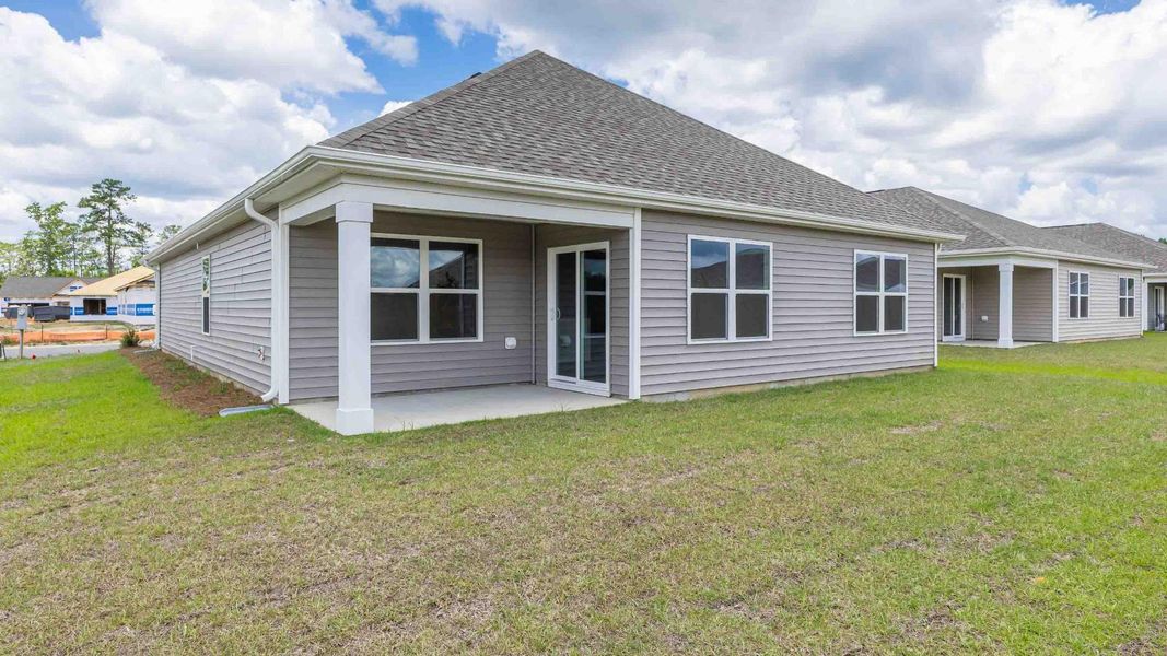 Exterior details and patio area of a home in Cedar Hill Landing, Navassa (Image 3).