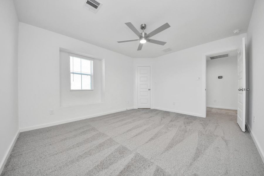 Generously sized secondary bedrooms featuring spacious closets, soft and inviting carpeting underfoot, large windows allowing plenty of natural light, and the added touch of privacy blinds for your personal retreat. Sample photo of completed home with similar floor plan. Actual colors and selections may vary.