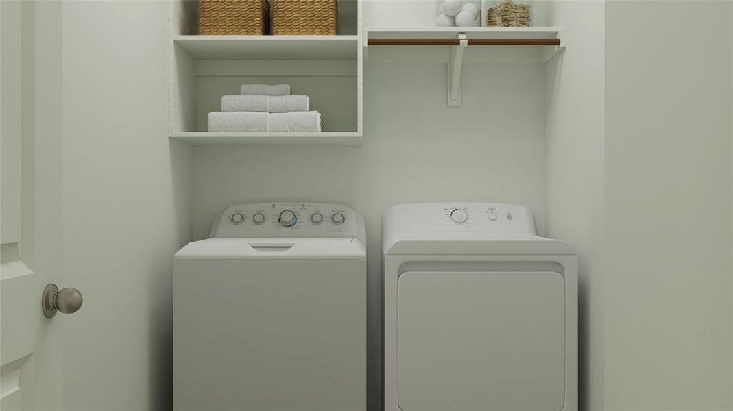 Clothes washing area featuring washer and dryer