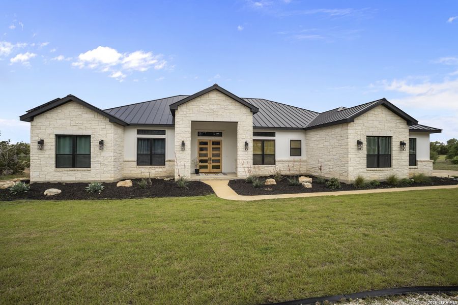 Front exterior of a new home in , Bulverde, TX, highlighting curb appeal (Image 20).