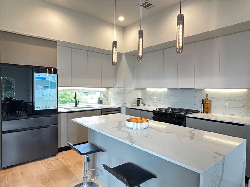 The kitchen includes a premium Samsung Bespoke refrigerator, combining high-end style with smart functionality.