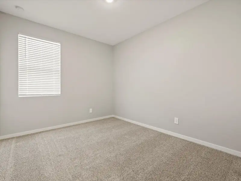 Spacious, unfurnished interior of a new home in Blossom Rock Reserve Series, Apache Junction (Image 15).