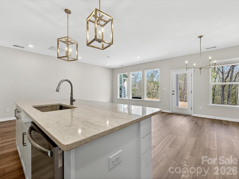 42" cabinets with soft close doors & drawers, Quartz countertops, tile backsplash, Frigidaire gallery appliances. Ship accent Island. Cooking exhaust vented to the outside. Enjoy views of the private wooded backyard