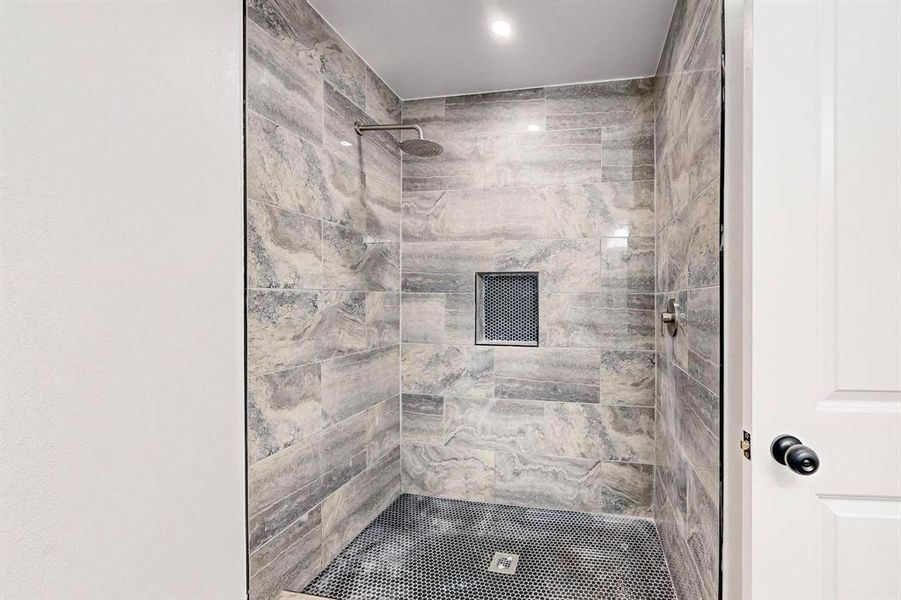 Bathroom featuring tiled shower