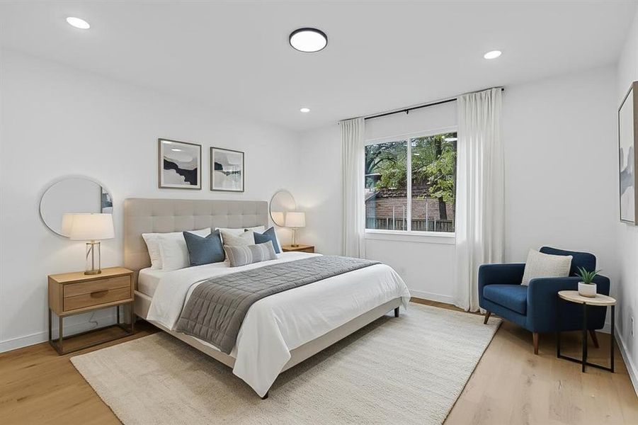Bedroom with light wood-style flooring and recessed lighting Bedroom with light wood-style flooring and recessed lighting