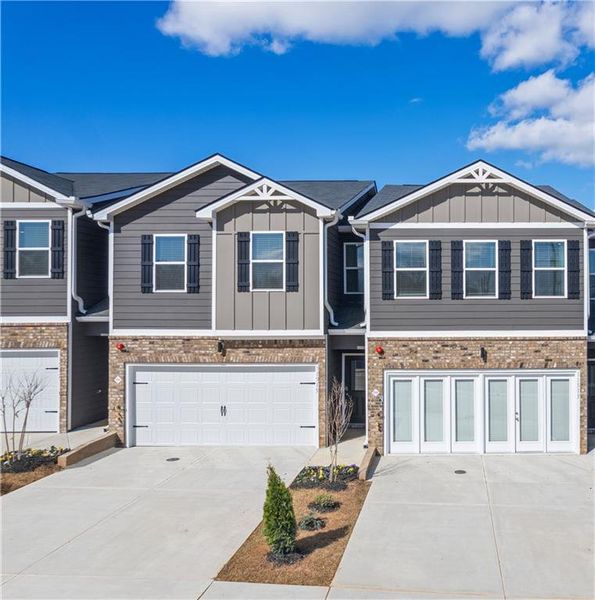 Front exterior of a new home in The Enclave Townhomes, Hampton, GA, highlighting curb appeal (Image 1). Front exterior of a new home in The Enclave Townhomes, Hampton, GA, highlighting curb appeal (Image 1).