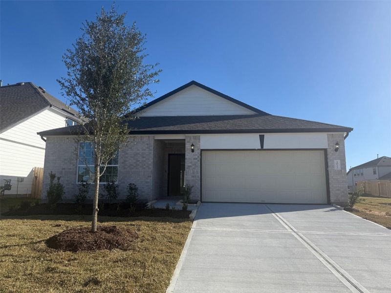 Front exterior of a new home in Bluestem, Brookshire, TX, highlighting curb appeal (Image 2). Front exterior of a new home in Bluestem, Brookshire, TX, highlighting curb appeal (Image 2).