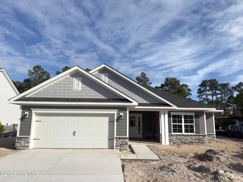 Front exterior of a new home in Rutledge, Shallotte, NC, highlighting curb appeal (Image 1). Front exterior of a new home in Rutledge, Shallotte, NC, highlighting curb appeal (Image 1).