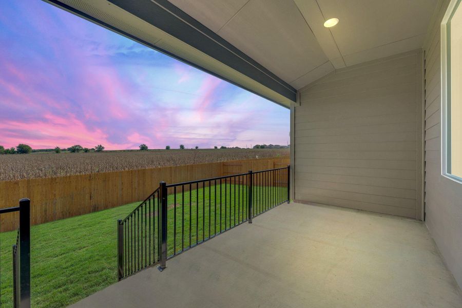 Balcony at dusk with a patio and a view of countryside Balcony at dusk with a patio and a view of countryside