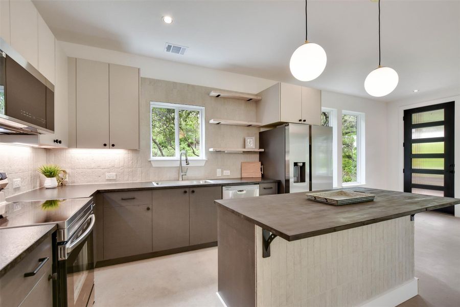 Kitchen features leathered granite and buctch block walnut island. Stainless appliances. Fridge included