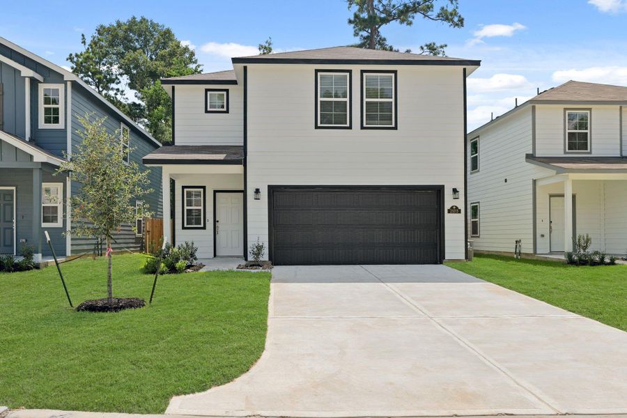 Front exterior of a new home in Maple Heights, Porter, TX, highlighting curb appeal (Image 8). Front exterior of a new home in Maple Heights, Porter, TX, highlighting curb appeal (Image 8).