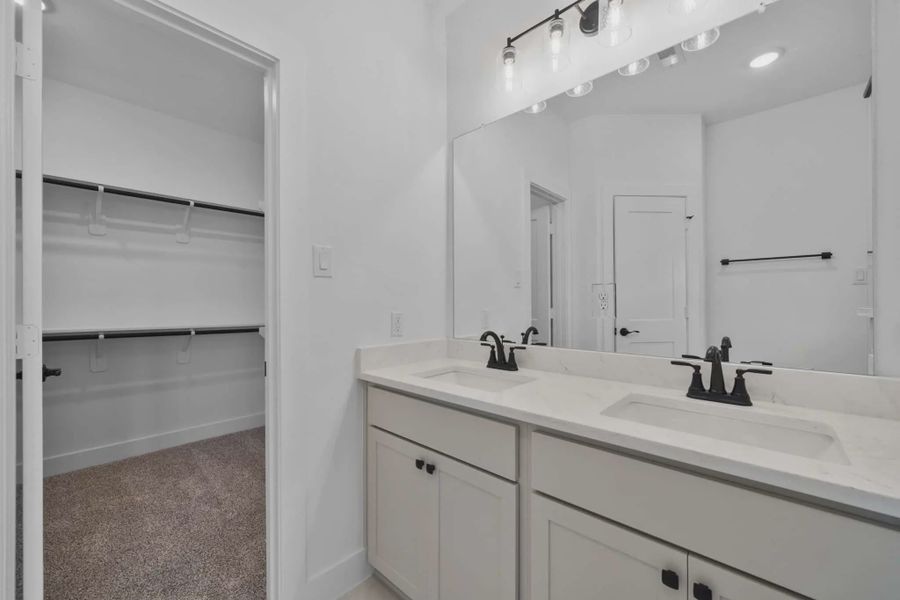Representative furnished interior of a home built from the Carriagehouse by Chesmar Homes in Meridiana Townhomes, Iowa Colony (Image 8).