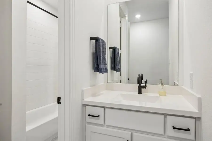 Bathroom vanity with an integrated sink, quartz countertop, and matte black faucet Bathroom vanity with an integrated sink, quartz countertop, and matte black faucet