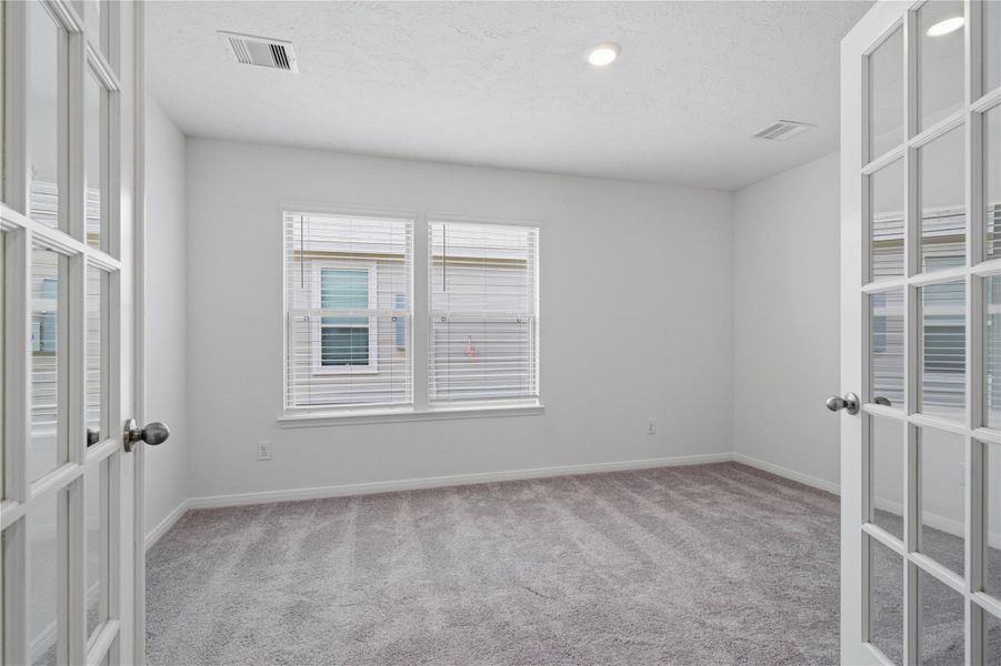 The Den offers a versatile space that seamlessly expands your living options—perfect for a home office, playroom, media space, or whatever suits your lifestyle.