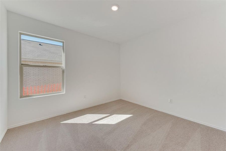 Spare room featuring light colored carpet