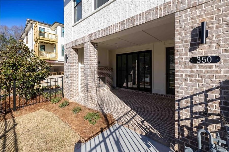 The terrace level entry has a beautiful covered, brick patio.