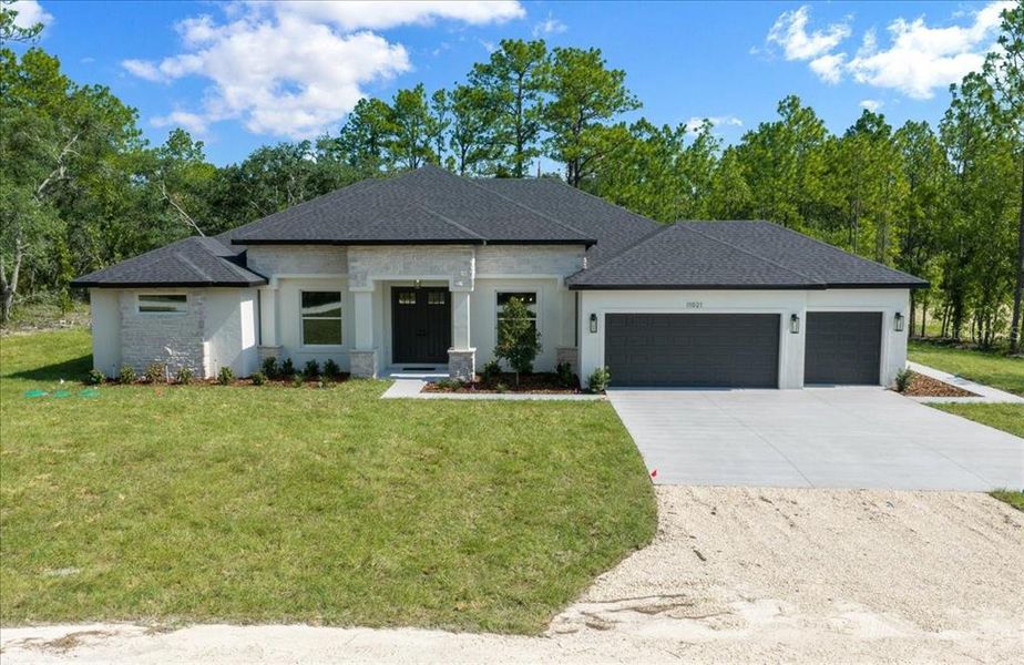 Front exterior of a new home in , Weeki Wachee, FL, highlighting curb appeal (Image 31). Front exterior of a new home in , Weeki Wachee, FL, highlighting curb appeal (Image 31).