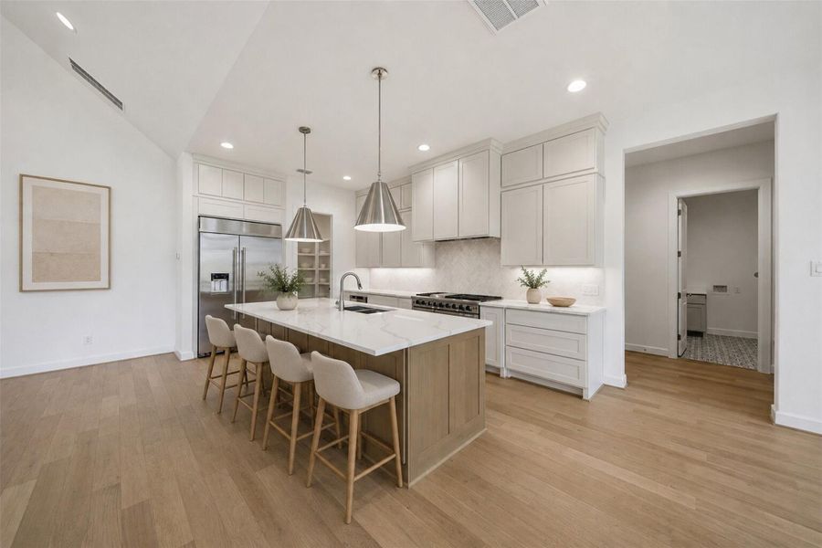 **Virtually Staged** Chef-inspired kitchen showcasing an oversized quartz island, custom cabinetry, premium appliances, and timeless designer finishes.