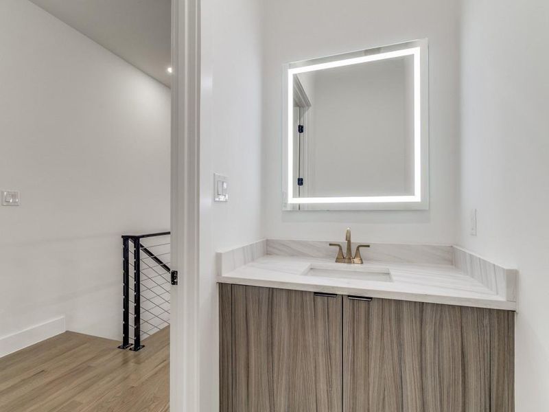 Bathroom featuring vanity and wood finished floors