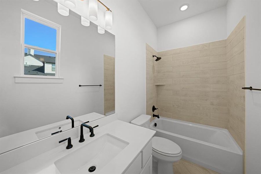 Full bath featuring vanity,  shower combination, and recessed lighting