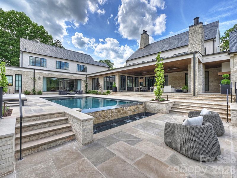 Outdoor pool area with plenty of open grass space