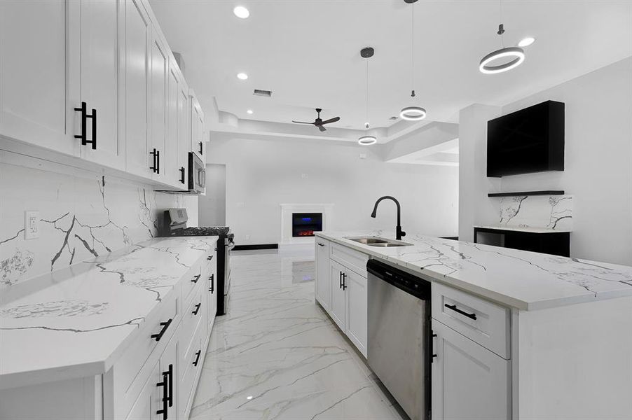 Enjoy the sleek modern kitchen with quartz countertops and cabinets that close softly. Cook with ease on the gas stove.