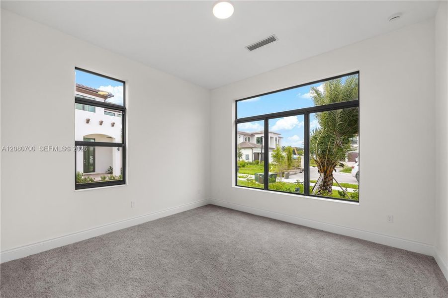 Recessed lighting, large format windows, high ceilings, and plush carpeting