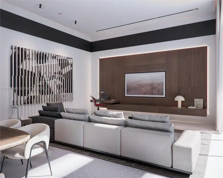 Wood-paneled accent wall featuring integrated recessed cabinetry, ambient perimeter lighting, and a linear floating desk Wood-paneled accent wall featuring integrated recessed cabinetry, ambient perimeter lighting, and a linear floating desk