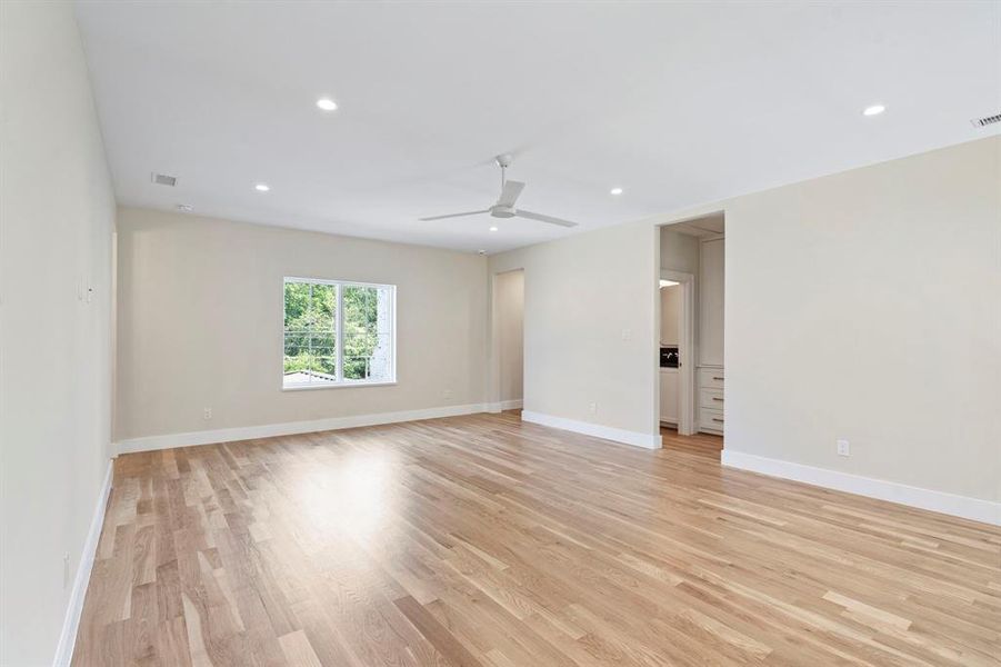 Empty room with light wood-type flooring and ceiling fan