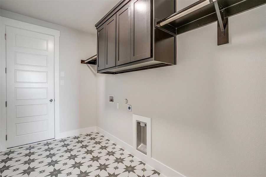 Laundry area with hookup for a washing machine, hookup for a gas dryer, cabinets, light tile patterned floors, and hookup for an electric dryer