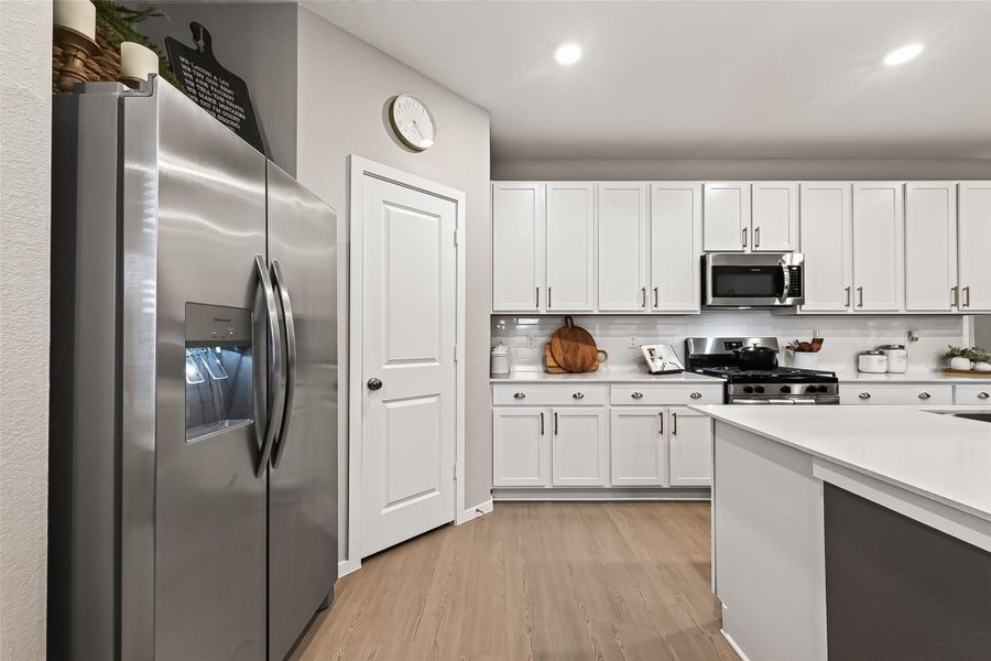 Bright kitchen with abundant cabinetry and stainless steel appliances. Bright kitchen with abundant cabinetry and stainless steel appliances.