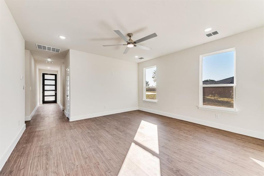 Spare room featuring ceiling fan and light hardwood / wood-style flooring