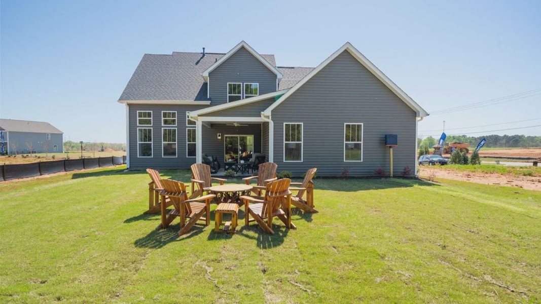 Warm and inviting outdoor living space with a covered rear porch and tasteful finishes at Benjamin's Grove