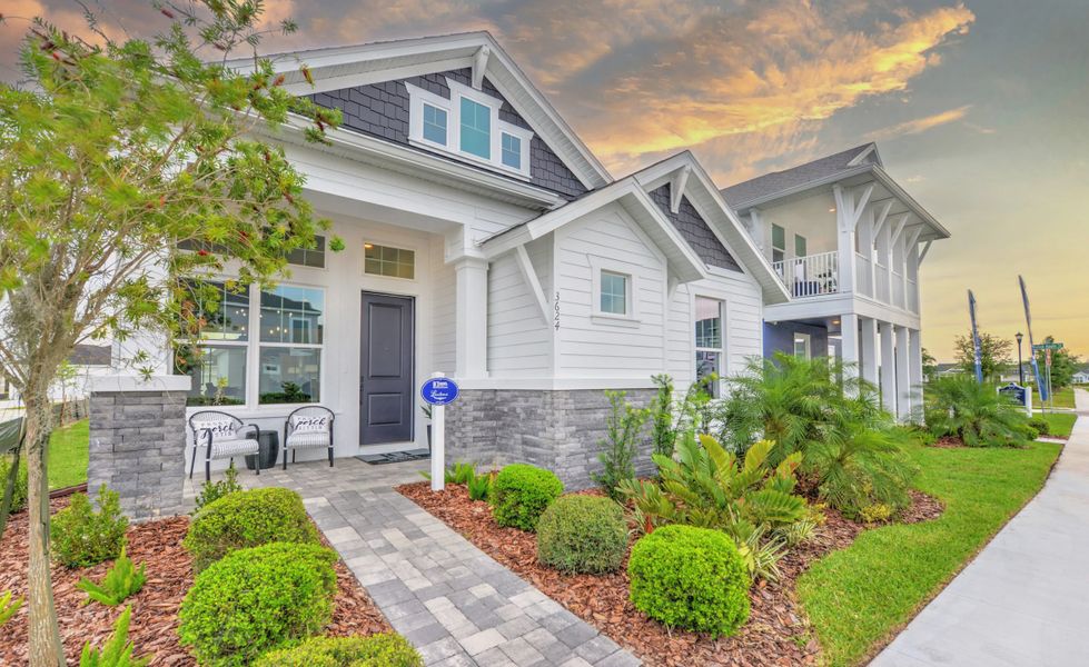 Front exterior of a new home in Persimmon Park, Wesley Chapel, FL, highlighting curb appeal (Image 2). Front exterior of a new home in Persimmon Park, Wesley Chapel, FL, highlighting curb appeal (Image 2).
