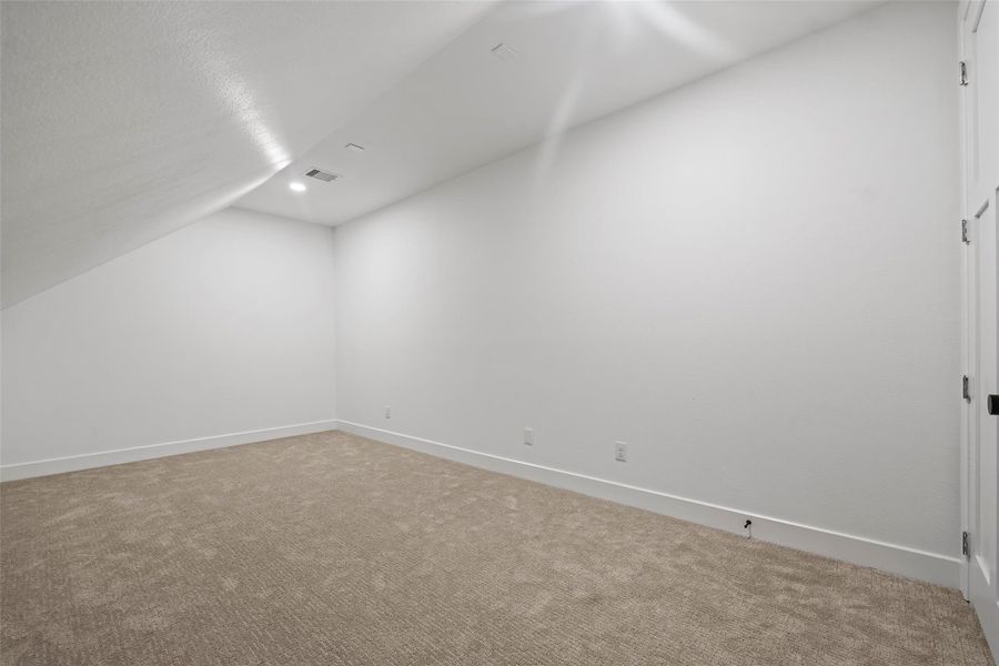 Spacious upstairs game/media room, perfect for entertainment and relaxation.