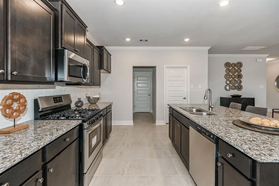 view of hall that leads to half bath on left and large walk-in pantry on rightNot actual house, for reference only