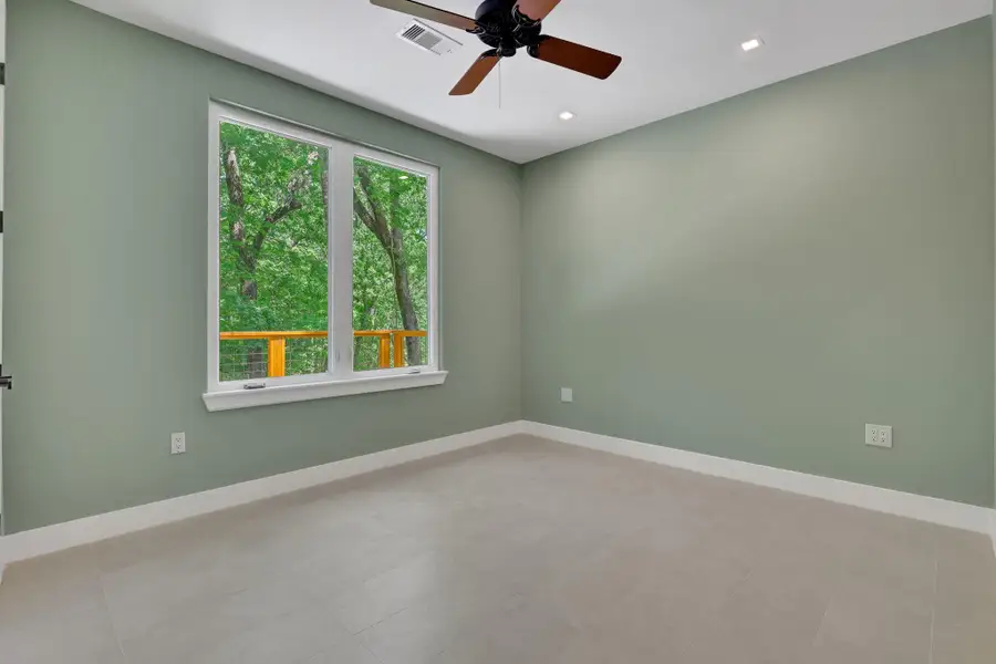 Spacious second guest bedroom overlooking the back of the property for peaceful forest views