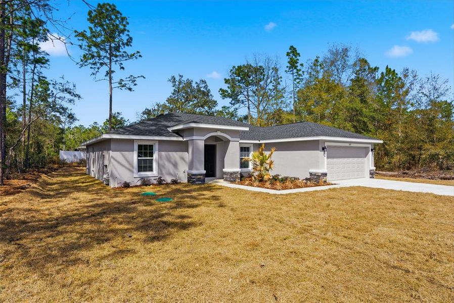 Front exterior of a new home in , Citrus Springs, FL, highlighting curb appeal (Image 30). Front exterior of a new home in , Citrus Springs, FL, highlighting curb appeal (Image 30).