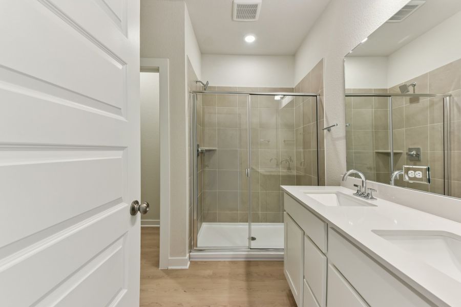 A bathroom with a glass shower. A bathroom with a glass shower.