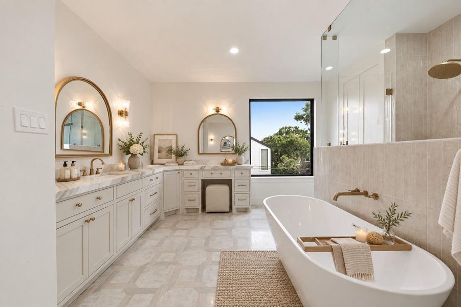 Master bathroom with stand alone tub, glass double entry double head shower, his and hers sinks and separate vanity area for her and marble countertops