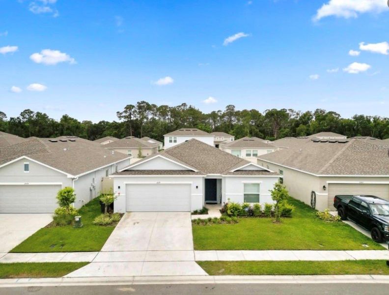 Front exterior of a new home in Ironwood, Lakeland, FL, highlighting curb appeal (Image 1). Front exterior of a new home in Ironwood, Lakeland, FL, highlighting curb appeal (Image 1).